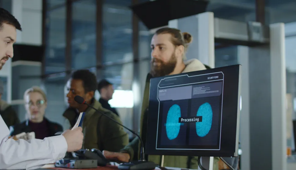 Man giving fingerprints with sensor