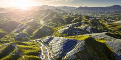 horizon of green hills with solar panels