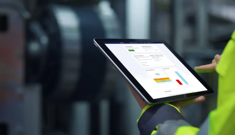 worker looks at Synergi Life software on tablet