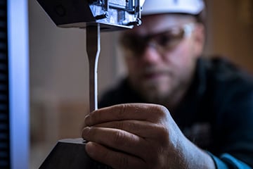 Lab engineer setting up a tensile test